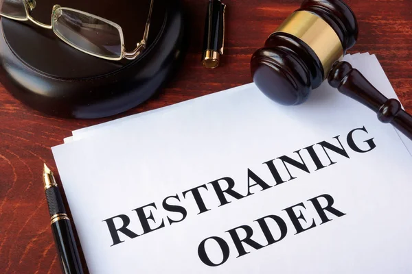 Restraining order and gavel on a table. — Stock Photo, Image