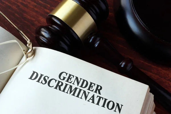 Book with chapter gender discrimination and a gavel. — Stock Photo, Image