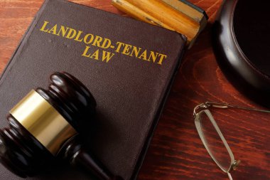 Book with title Landlord-Tenant Law and a gavel. clipart