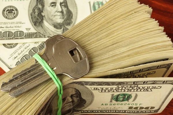 Pack of dollars and keys from house. Real estate concept. — Stock Photo, Image