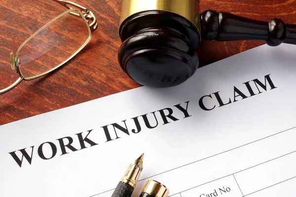Worker compensation. Work injury claim on a table. — Stock Photo, Image