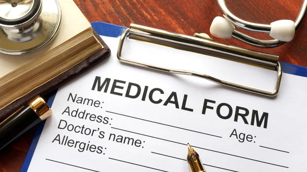 Pojęcie opieki zdrowotnej. Stetoskop i formularz medyczny na stole. — Zdjęcie stockowe