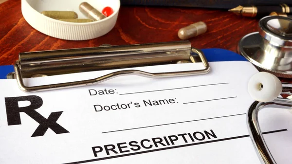 Prescription form in a hospital and ills and capsules. — Stock Photo, Image