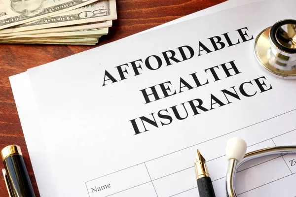 Affordable health insurance policy on a table.