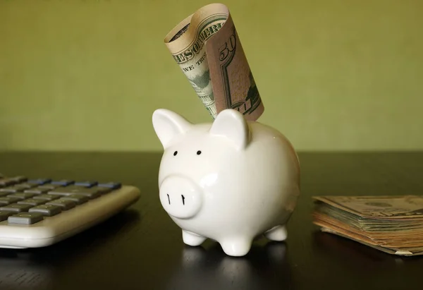 Besparingen concept. Piggy bank, rekenmachine en dollars. — Stockfoto