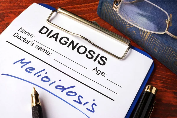 Form with diagnosis Melioidosis on a table. — Stock Photo, Image