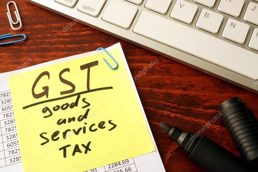 Notepad with word GST Goods and services tax.