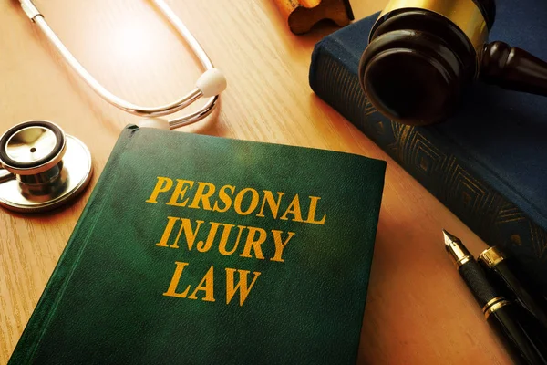 Personal injury law book on a table. — Stock Photo, Image