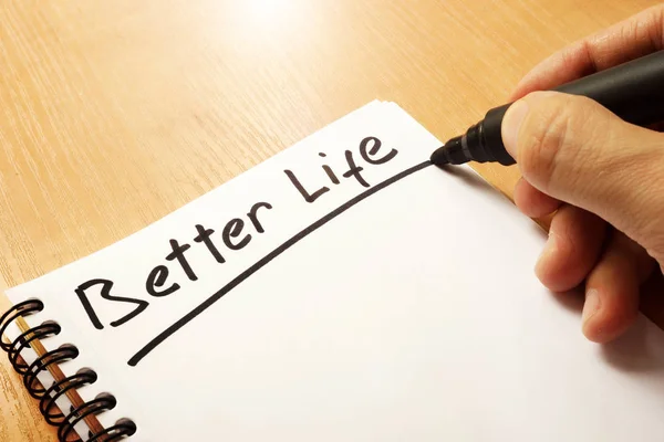 Hand is writing A Better Life on a note. — Stock Photo, Image