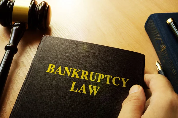 Hands holding Bankruptcy Law in a court. — Stock Photo, Image