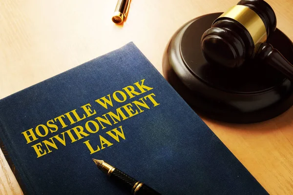 Hostile work environment law on an office table. — Stock Photo, Image