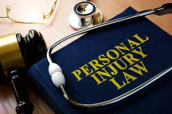 Personal Injury Law concept. Book and stethoscope. — Stock Photo, Image