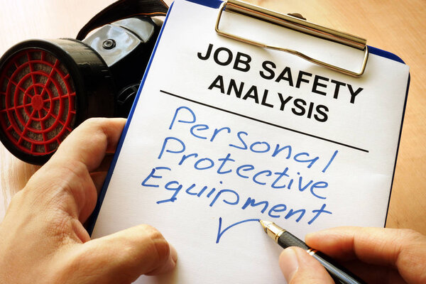 Man is writing words Personal protective equipment (PPE).