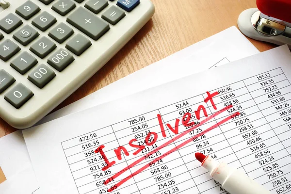 Insolvent written on a paper with financial figures. — Stock Photo, Image