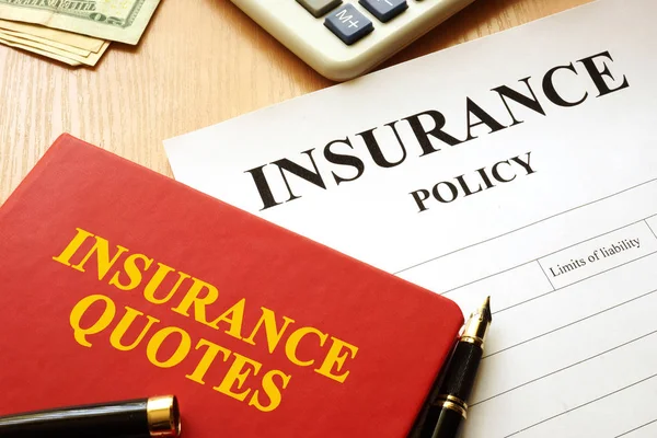 Insurance quotes book and policy on a desk. — Stock Photo, Image