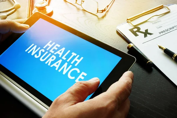 Words Health insurance on a screen of tablet. — Stock Photo, Image