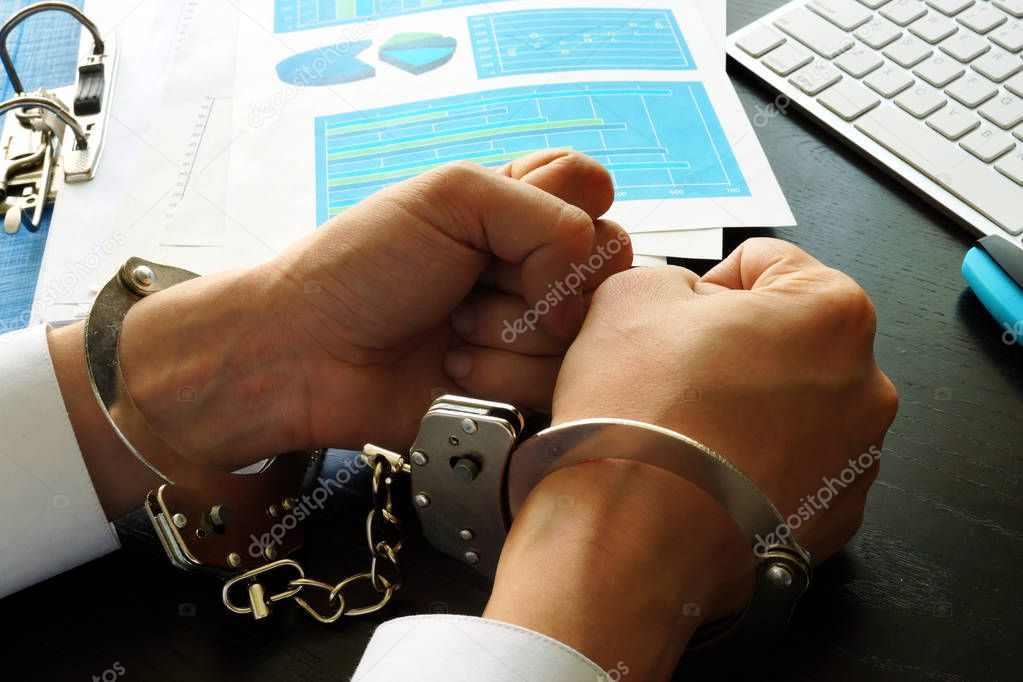 White collar crime concept. Businessman in handcuffs.