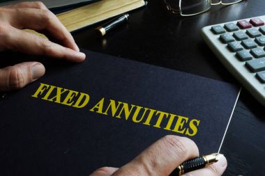 Fixed Annuities. Book on an office table. clipart