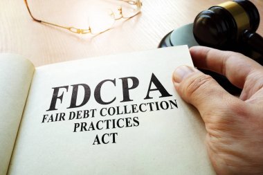 Fair Debt Collection Practices Act FDCPA on a table. clipart