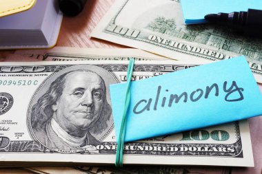 Pile of dollars with word alimony on a stick. clipart