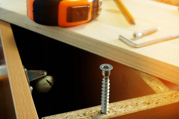 Furniture assembling. Parts of cabinet and screw close up. — Stock Photo, Image