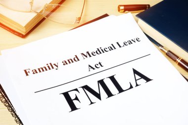 FMLA Family and Medical Leave Act on a desk. clipart