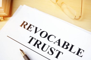 Revocable trust on a wooden desk. clipart