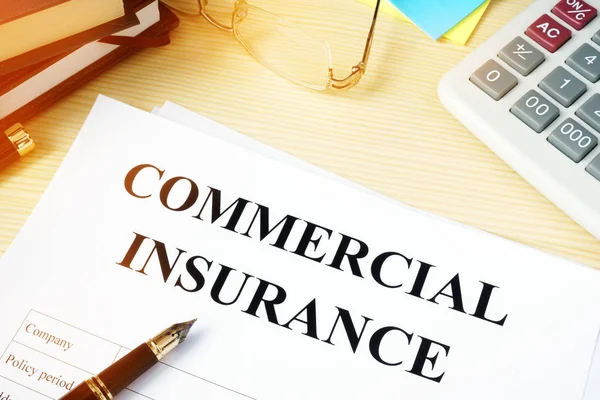 Commercial insurance policy on an office desk. — Stock Photo, Image
