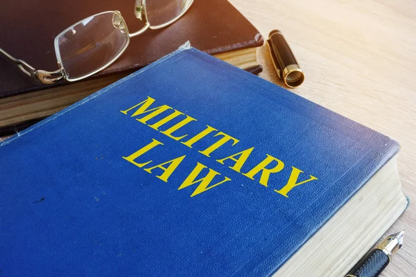 Military Law code on a desk.