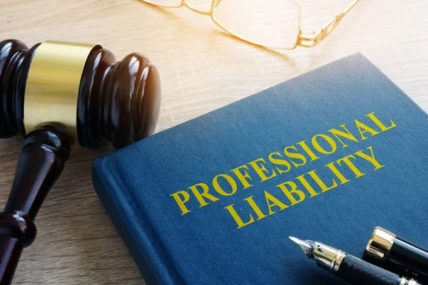 Professional liability on a court table. — Stock Photo, Image