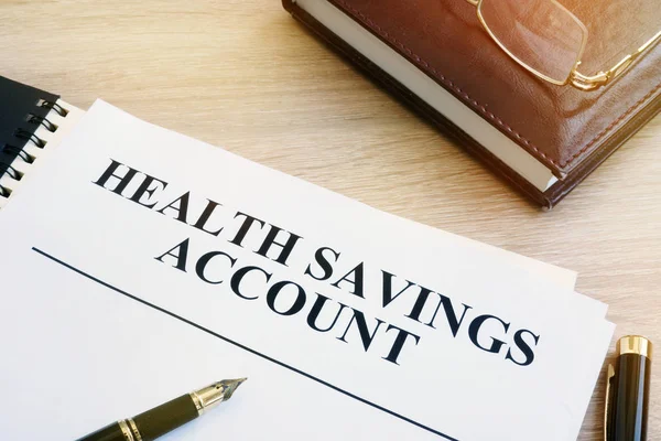 Papers about Health savings account (HSA) on a desk.