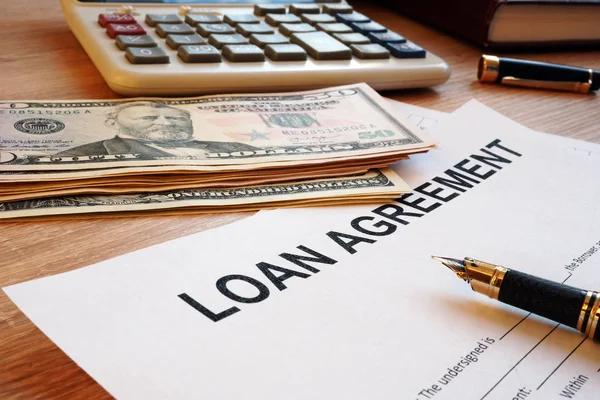 Loan agreement and dollar bills on an office desk. — Stock Photo, Image