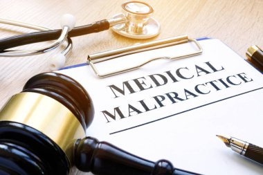 Clipboard with documents about medical malpractice and gavel. clipart