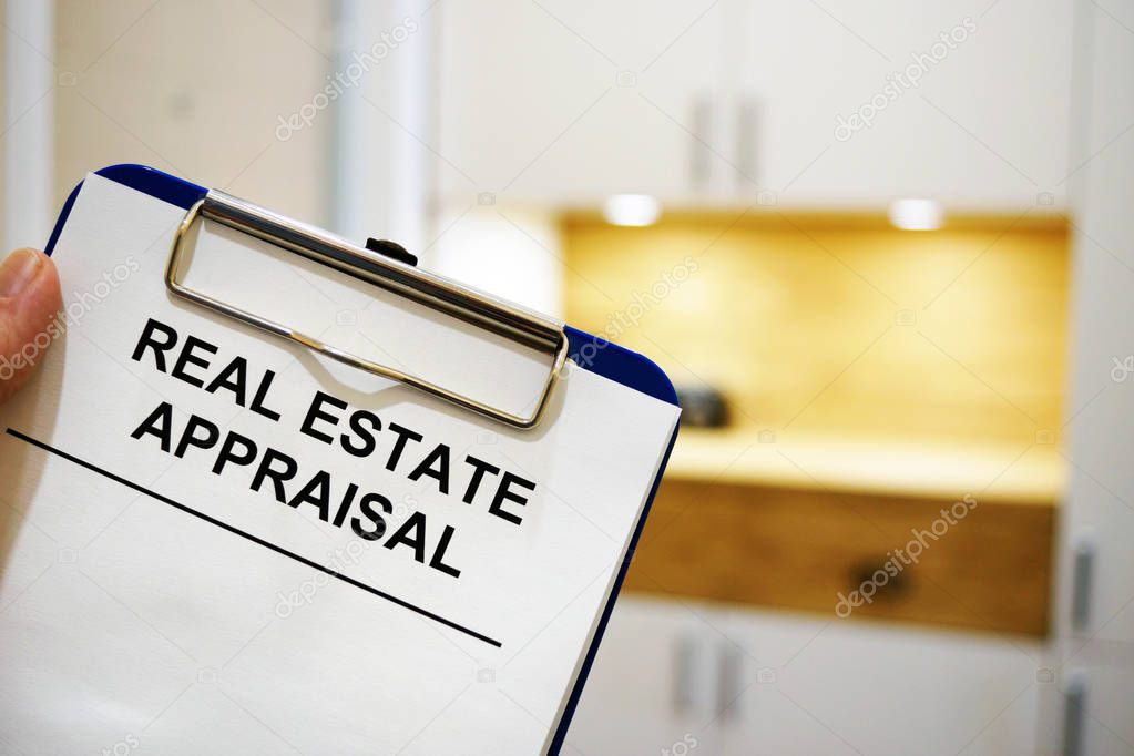 Man holding clipboard with Real estate appraisal.