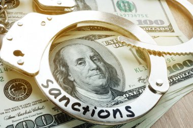 Bir kelepçe üzerinde kelime yaptırımlar ve Amerikan dolarları. Ekonomik kısıtlayıcı tedbirler.
