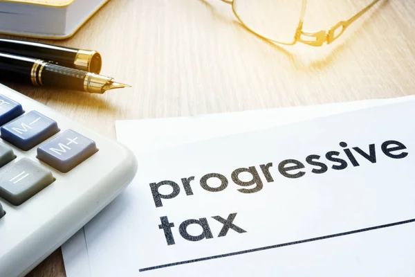 Papers about progressive tax on an office desk. — Stock Photo, Image