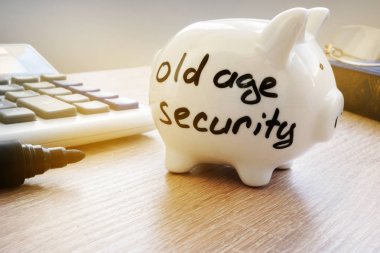 Old Age Security (OAS) written on a side of piggy bank. clipart
