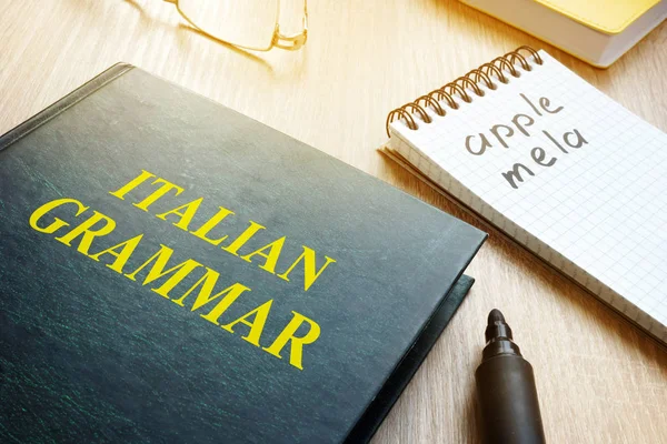 イタリア語の文法を学ぶ。本とテーブルの上のノート. — ストック写真