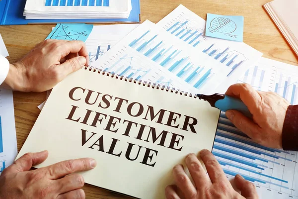Men read Customer lifetime value conception in book. — Stock Photo, Image