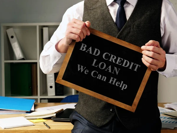 Man with sign Bad Credit Loan we can help.