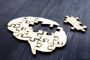 Brain from wooden puzzles. Mental Health and problems with memory. clipart