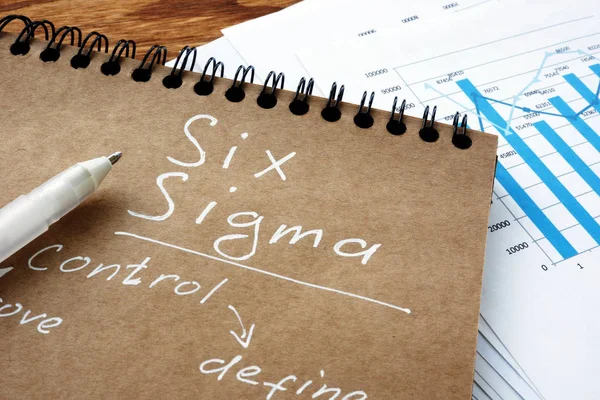 Six sigma sign as Lean Manufacturing concept. Notebook and papers. — Stock Photo, Image