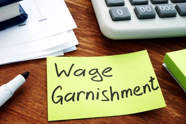 Wage Garnishment written on the yellow sheet. — ストック写真