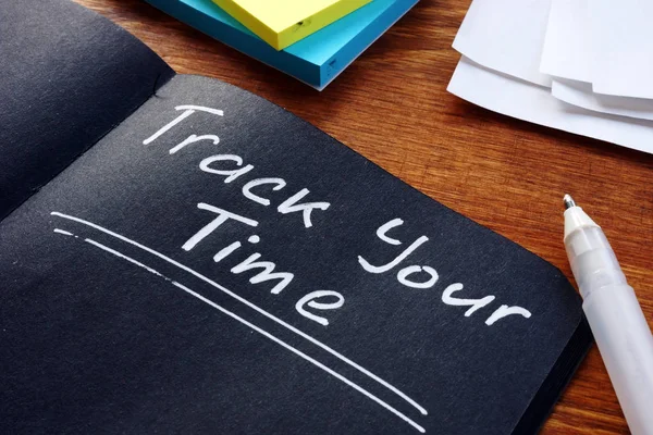 Time management concept. Track Your Time phrase handwritten on the black sheet. — Stock Photo, Image