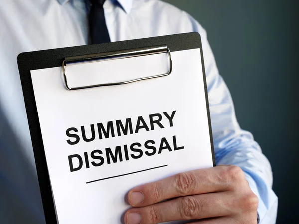 Man holds summary dismissal notice in the hands. — Stock Photo, Image
