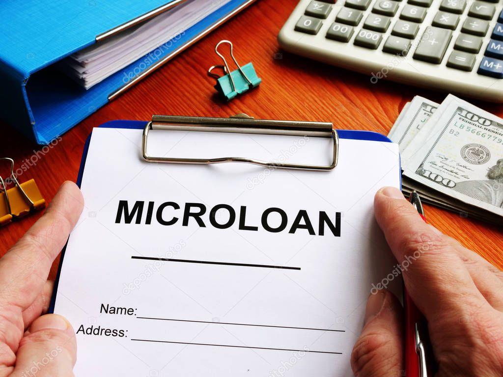 Microloan application form with money for lending.