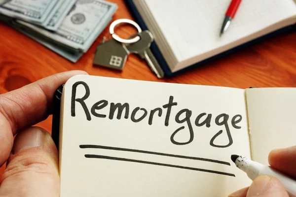 Remortgage handwritten word by man. — Stock Photo, Image