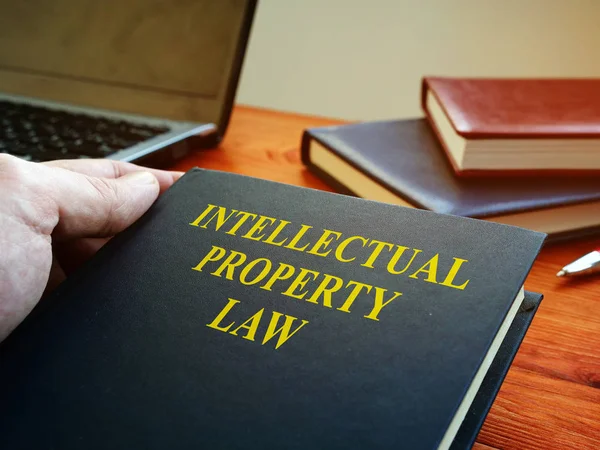 Lawyer is holding intellectual property law book. — 스톡 사진