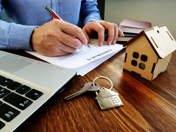 El hombre firma un contrato sobre hipoteca o compra de propiedades . —  Fotos de Stock