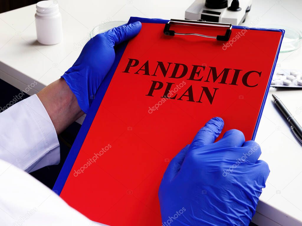 Doctor is reading pandemic plan for preparedness.
